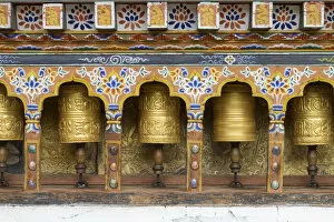 Bhutan Gallery: Bhutan. Spinning prayer wheels along a temple wall