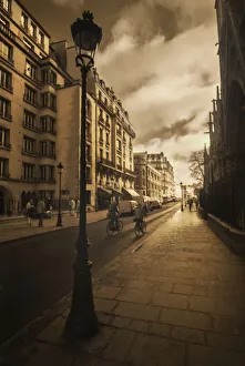 Bicycle Prints: Bicycle riders beside Notre Dame Cathedral and her gargoyles in Paris, France