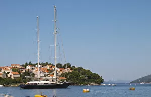 A very big luxurious pleasure sailing ship yacht with two masts, called Santa Maria leaving harbour