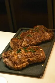 Two big roasts of beef with herbs on them, thyme and rosemary. The Dolly Irigoyen - famous chef