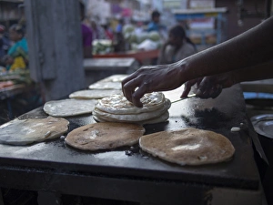 Images Dated 24th December 2012: Bits of dougH are rolled into mounds Tto be cooked in Bangalore, Karnataka, India