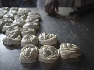 South Asia Prints: Bits of dougH are rolled into mounds Tto be cooked in Bangalore, Karnataka, India