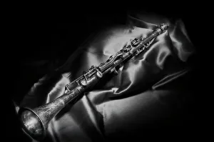 Black And White Prints: A black and white still life image of a brass clarinet