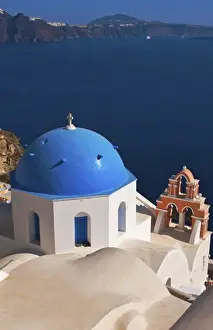 Prints of Blue domb church of beautiful Oia in Greek Island of Santorini Greece on cliffs on holiday Images Dated 2028 September: Blue domb church of beautiful Oia in Greek Island of Santorini Greece on cliffs