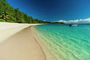 Away From It All Prints: A boat anchored off the shore of a pristine tropical beach. Denis Island, Seychelles