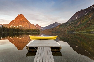 Boats on calm morning at Two Medicine Lake in Glacier National Park, Montana, USA