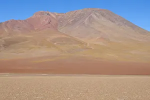 Place Prints: Bolivia, Atacama Desert. Yellow grasses add color to the red mountain in the desert