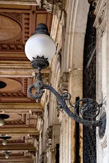 Emilia Romagna Prints: Bologna, Emilia-Romagna, Italy - An ornate lamp is mounted on a building wall. Decorative