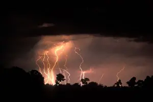 Dry Season Prints: Botswana, Moremi Game Reserve, Lightning fills sky over Khwai River at end of dry