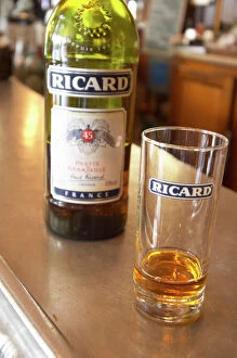 Trending: A bottle of Ricard 45 pastis and a glass on a zinc bar in a cafe bar in Paris Pastis