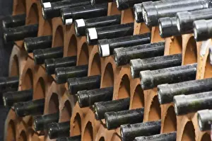 Storage Prints: Bottles laying down piled high in terracotta earthenware tube containers. VitaI Vitaai