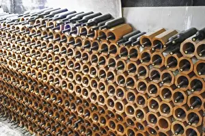 Storage Prints: Bottles stored laying down piled high in terracotta earthenware tube containers
