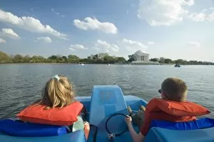 Boy (age 8) and girl (age 6) on paddleboat in lake near Jefferson Memorial, Washington D