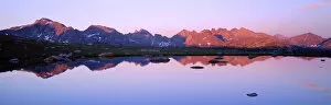 BRIDGER WILDERNESS, WYOMING. USA. Peaks of the Continental Divide reflected in tarn at sunset