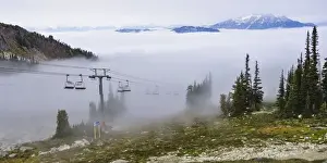 Images Dated 22nd September 2012: British Columbia, Whistler. Chairlift coming out above the clouds on Whistler Mountain