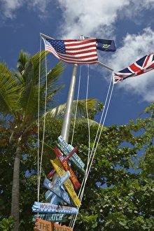 Images Dated 25th February 2014: British Virgin Islands, Marina Cay. Colorful flags and direction signs
