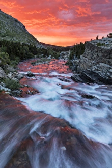 Images Dated 8th July 2016: Brlliant sunrise sky over Swiftcurrent Falls in Glacier National Park, Montana, USA