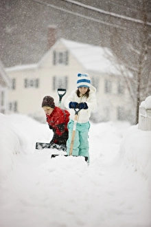 Jerry Marcy Monkman Prints: A brother and sister shovel snow during a snowstorm in Portsmouth, New Hampshire