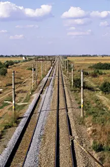 Transporting Prints: Bucharest, Romania. Electrified railway line with fresh laid ballast stretching into