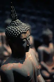 Buddhism Prints: Buddha statues dry in the hot sun of a Phitsanulok Buddha statue factory