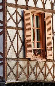 Rhone Prints: A building in the town with old half timber facade and wooden shutters