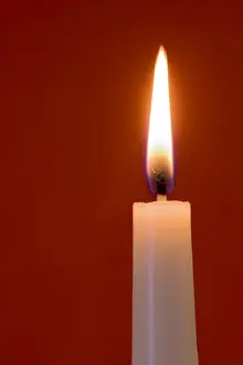 Burning Prints: Burning candle on red background