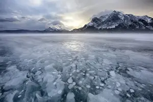 Images Dated 12th February 2014: Canada, Alberta, Abraham Lake. Winter sunrise over lake and Mount Michener. Credit as