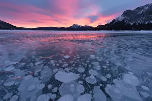 Canada, Alberta, Abraham Lake. Winter sunrise over lake and Mount Michener. Credit as