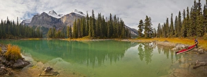 Images Dated 29th September 2011: Canada, Alberta, Jasper National Park. A male sea kayaker launches a kayak on Maligne Lake