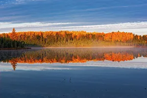 Images Dated 24th April 2022: Canada, Manitoba, Duck Mountain Provincial Park. Morning fog on lake in autumn
