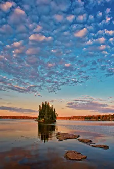 Images Dated 24th April 2022: Canada, Manitoba, Paint Lake Provincial Park. Island on Paint Lake at sunrise