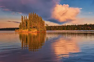 Images Dated 24th April 2022: Canada, Manitoba, Paint Lake Provincial Park. Island on Paint Lake at sunrise
