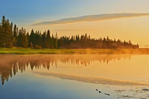 Canada, Manitoba, Riding Mountain National Park. Fog rising above Whirlpool Lake