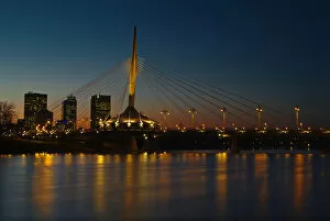 Images Dated 25th October 2004: Canada, Manitoba, Winnipeg. Esplanade Riel bridge and city skyline reflected in Red River at dusk