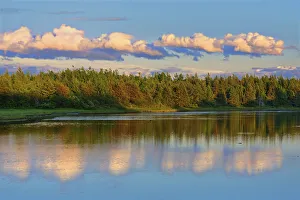 Images Dated 10th June 2015: Canada, New Brunswick, Richibucto. Clouds reflected in an inlet at sunset. Credit as