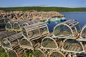 Barrier Prints: Canada, Nova Scotia, Neils Harbour. Boats and lobster traps in coastal village. Credit as