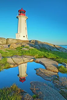 Canada, Nova Scotia. Peggys Cove Lighthouse reflection in water