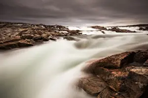 Canada, Nunavut Territory, Blurred image of rushing waterfall near Bury Cove along
