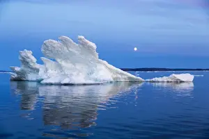 Images Dated 8th August 2014: Canada, Nunavut Territory, Moon rises behind melting iceberg in Frozen Channel