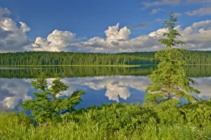 Canada, Ontario. Clouds reflected in Trail Lake. Credit as