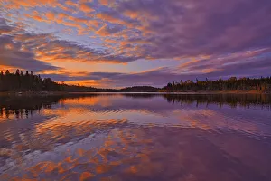 Images Dated 23rd March 2020: Canada, Ontario, Kenora District. Forest autumn colors reflect on Middle Lake at sunrise