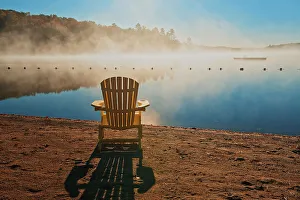 Prints of Canada, Ontario, Silent Lake Provincial Park. Muskoka chair and morning fog on Silent Lake Images Dated 2022 May: Canada, Ontario, Silent Lake Provincial Park. Muskoka chair and morning fog on Silent Lake