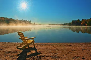 Images Dated 23rd May 2022: Canada, Ontario, Silent Lake Provincial Park. Muskoka chair and morning fog on Silent Lake
