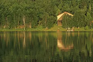 Canada, Ontario, Sudbury. Cottage on Tilton Lake at sunset