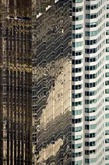 Canada, Ontario, Toronto. Contrast of abstract glass reflections and designs of two