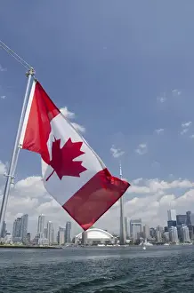 Downtown Prints: Canada, Ontario, Toronto. Lake Ontario city skyline view with CN Tower & Canadian flag