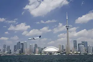 Canada, Ontario, Toronto. Lake Ontario city skyline view of the iconic CN Tower & the Rogers Centre