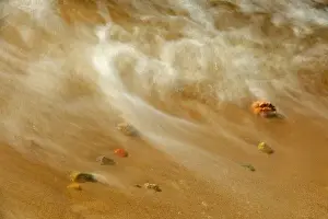 Pebble Prints: Canada, Ontario. Waves crashing against pebbles on shore of Lake Nipissing. Credit as
