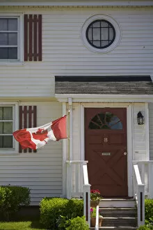 Images Dated 16th June 2007: Canada, Prince Edward Island, Charlottetown. Historic home flying Canadian flag
