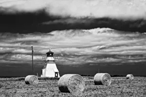 Images Dated 19th July 2009: Canada, Prince Edward Island, Darnley. Lighthouse and hay bales